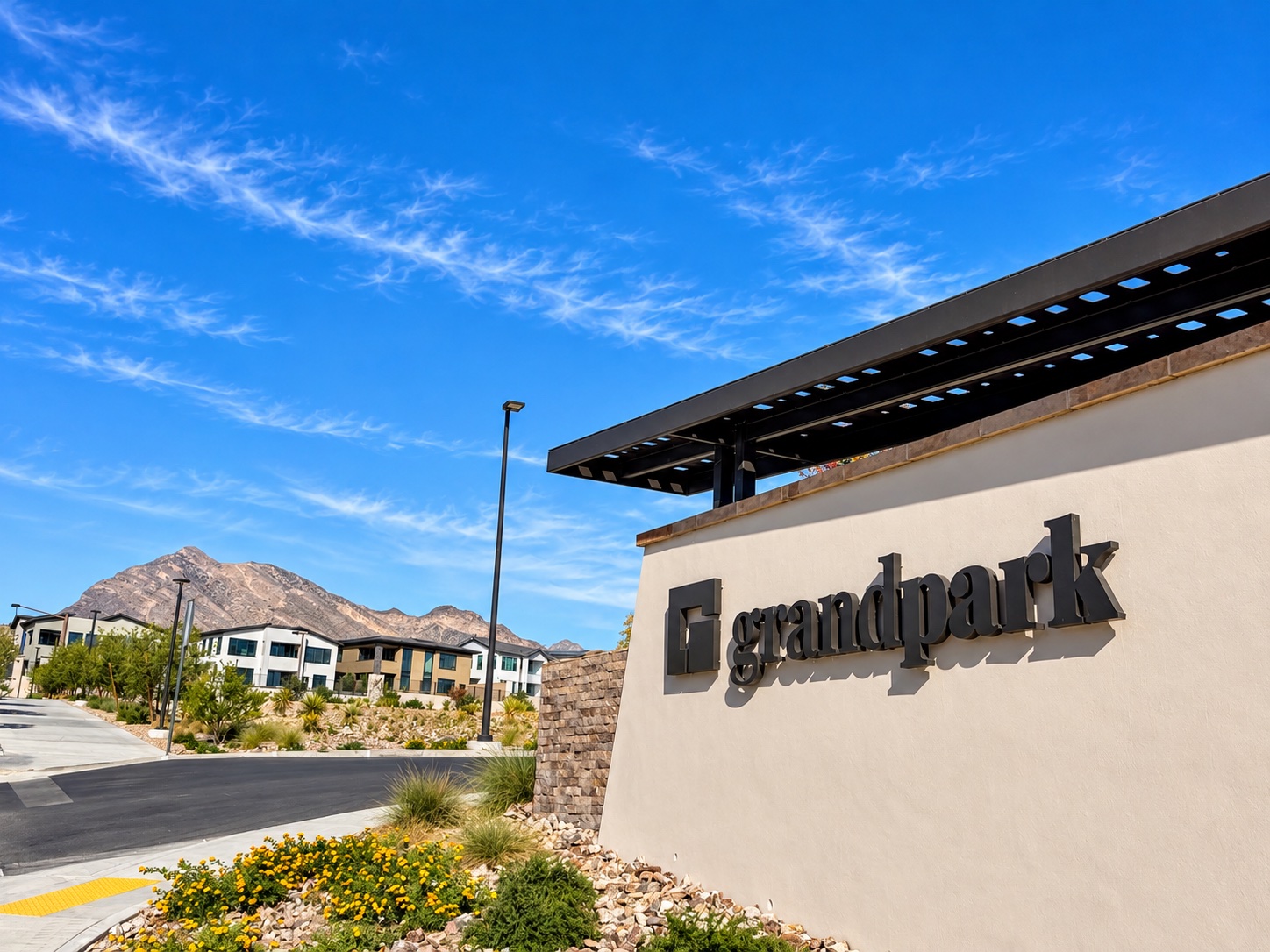 Grand Park entrance sign with mountains and homes in Summerlin West