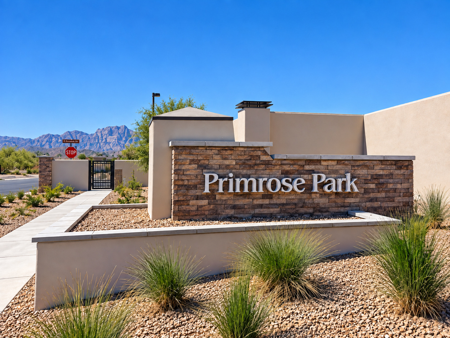 Primrose Park entrance sign with mountains in the background
