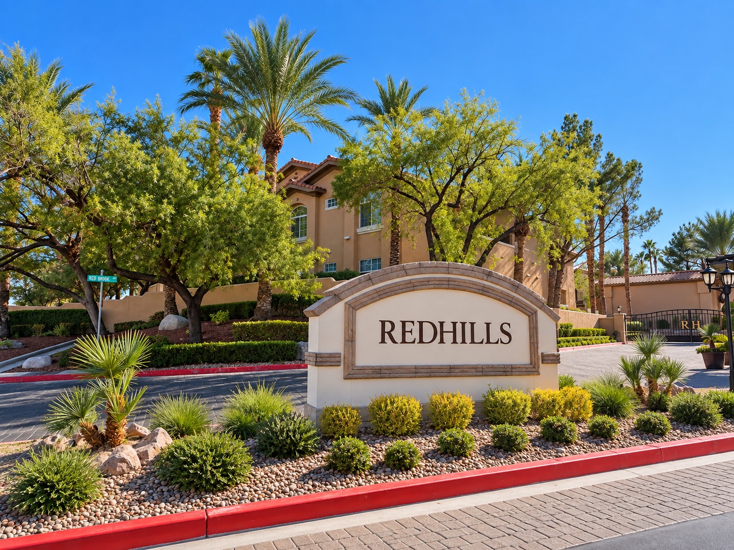 Redhills entrance sign, palm trees and desert landscaping in The Pueblo village of Summerlin, Las Vegas
