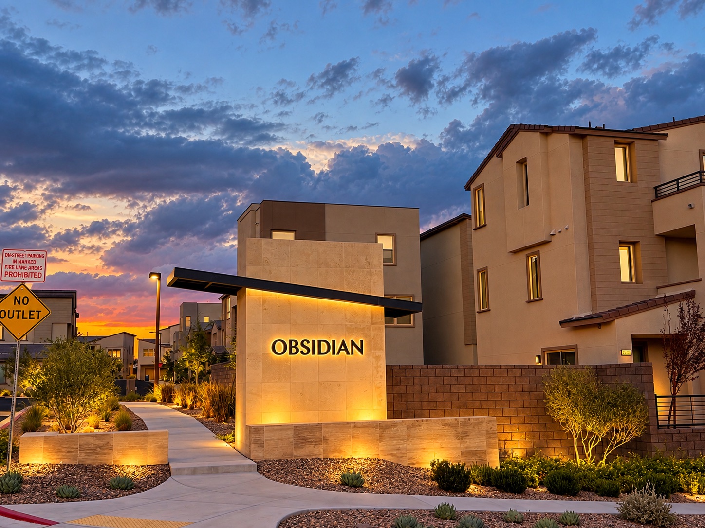 Illuminated Obsidian entrance sign and contemporary homes at dusk in Redpoint Square, Summerlin, Las Vegas